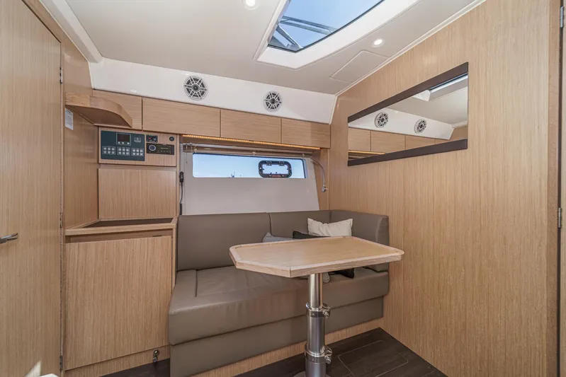Bag Secured Yacht Photos Pics Interior of 2023 Bavaria SR36 yacht with modern seating and wooden finishes.