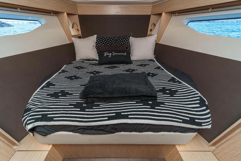 Bag Secured Yacht Photos Pics Luxurious cabin interior of 2023 Bavaria SR36 yacht with cozy bedding and stylish decor.