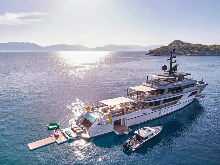 Para Bellum Yacht Photos Pics Sanlorenzo 500EXP yacht, 2023 model, anchored in serene waters with scenic island backdrop.
