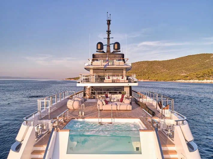 Para Bellum Yacht Photos Pics Luxurious 2023 Sanlorenzo 500EXP yacht with pool, cruising in serene waters.