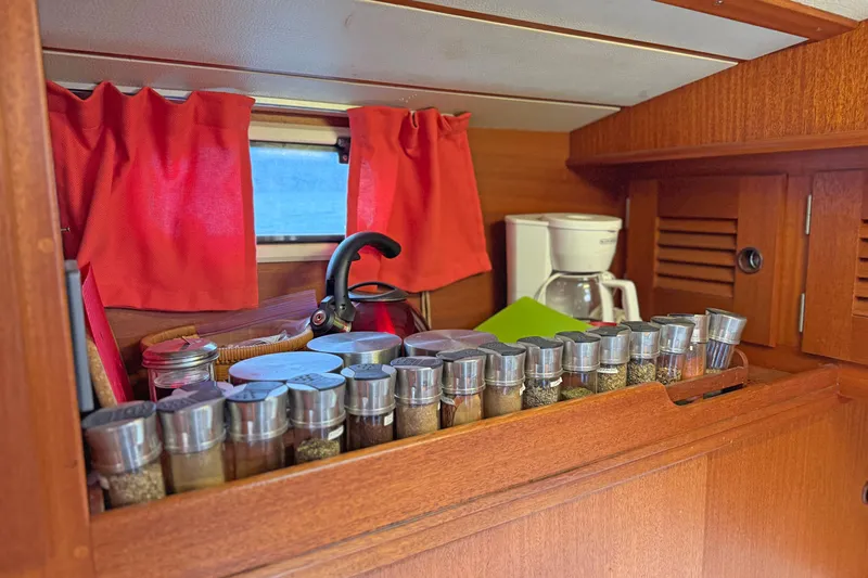 Raison D'etre Yacht Photos Pics Galley of 1988 Hallberg Rassy 42E with spices, kettle, and coffee maker.