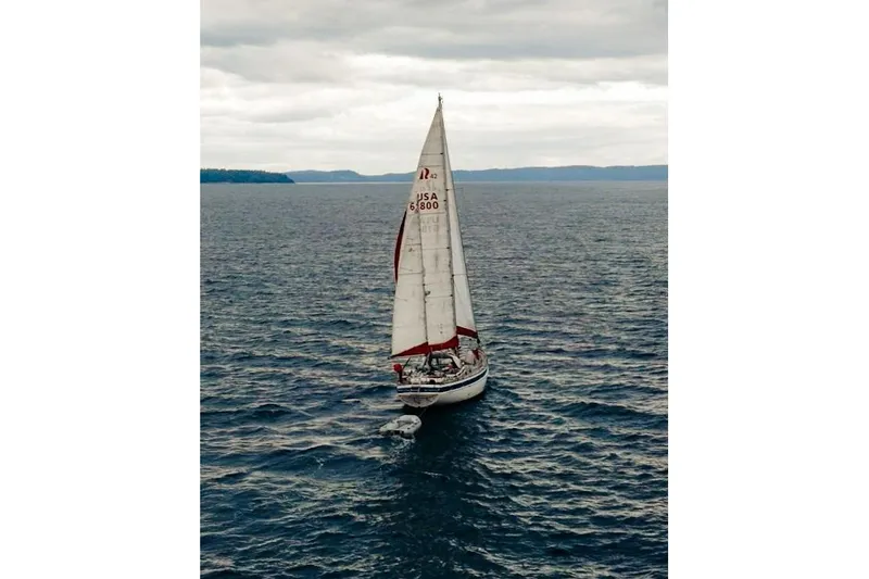 Raison D'etre Yacht Photos Pics Sailing yacht Hallberg Rassy 42E (1988) on open water under cloudy skies.