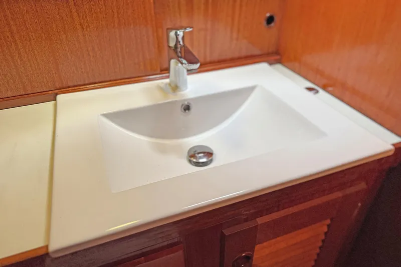 Raison D'etre Yacht Photos Pics White sink with chrome faucet in 1988 Hallberg Rassy 42E yacht bathroom.