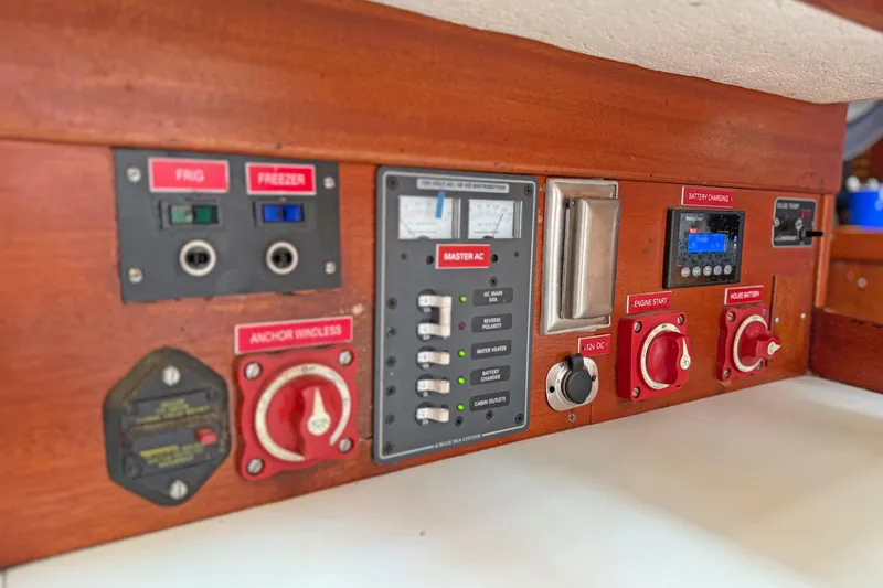 Raison D'etre Yacht Photos Pics Control panel of a 1988 Hallberg Rassy 42E yacht, featuring switches and gauges.