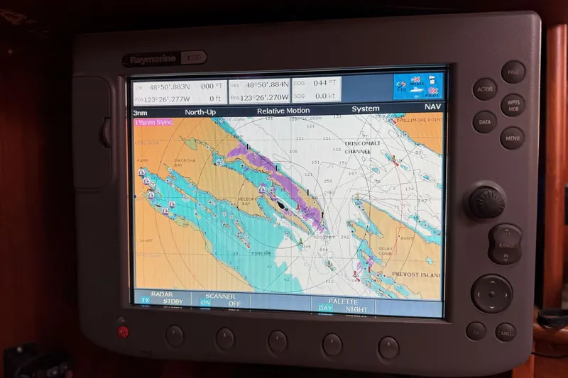 Raison D'etre Yacht Photos Pics Navigation system on 1988 Hallberg Rassy 42E sailboat displaying nautical chart.