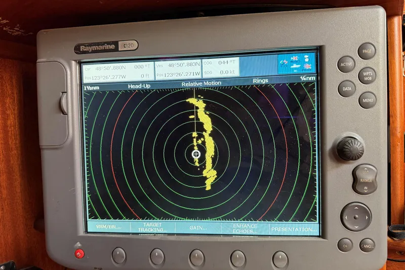 Raison D'etre Yacht Photos Pics Raymarine C120 radar display on 1988 Hallberg Rassy 42E sailboat, showing navigation data.