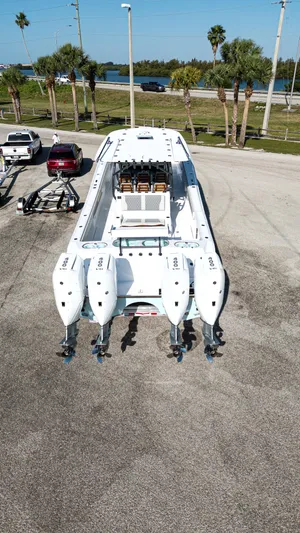  Yacht Photos Pics 2026 Front Runner 43 Catamaran with quad engines on a trailer, parked near palm trees.