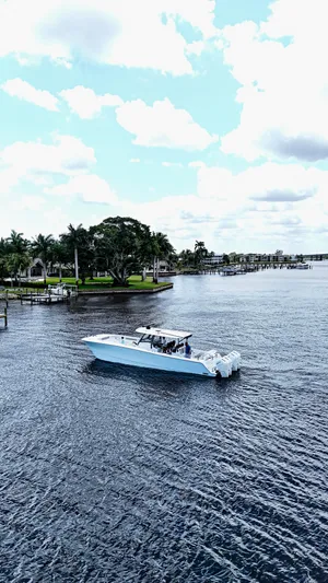  Yacht Photos Pics 2026 Front Runner 43 Catamaran cruising on a scenic waterway with lush greenery.