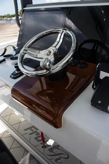  Yacht Photos Pics Steering wheel of 2026 Front Runner 43 Catamaran with modern dashboard controls.
