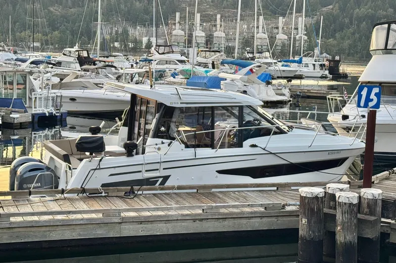  Yacht Photos Pics 2017 Jeanneau 895 Offshore boat docked in a marina with other vessels.