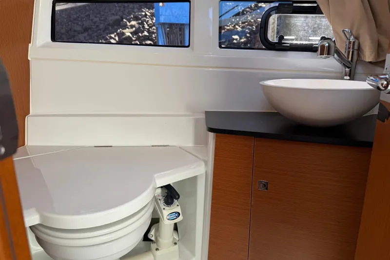  Yacht Photos Pics Interior of 2017 Jeanneau 895 Offshore boat bathroom with sink and toilet.