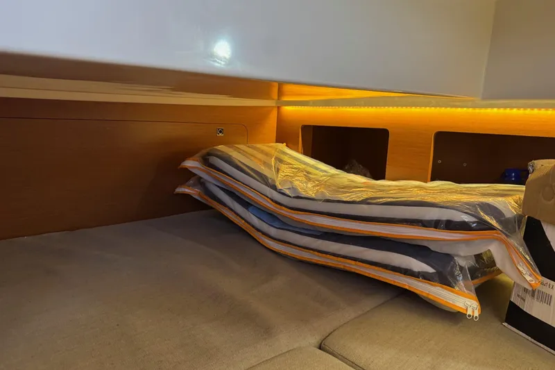  Yacht Photos Pics Interior cabin of 2017 Jeanneau 895 Offshore with cushions and ambient lighting.