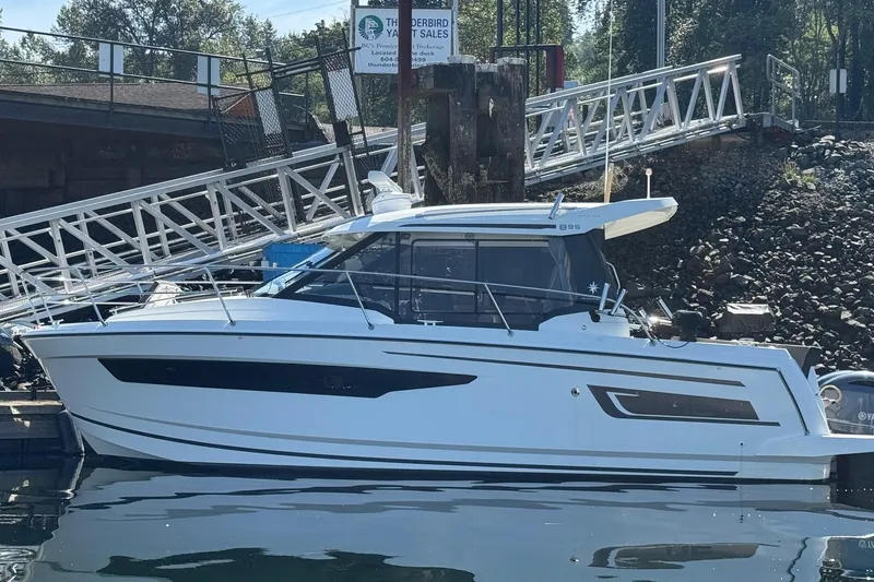  Yacht Photos Pics 2017 Jeanneau 895 Offshore boat docked at marina, side view.