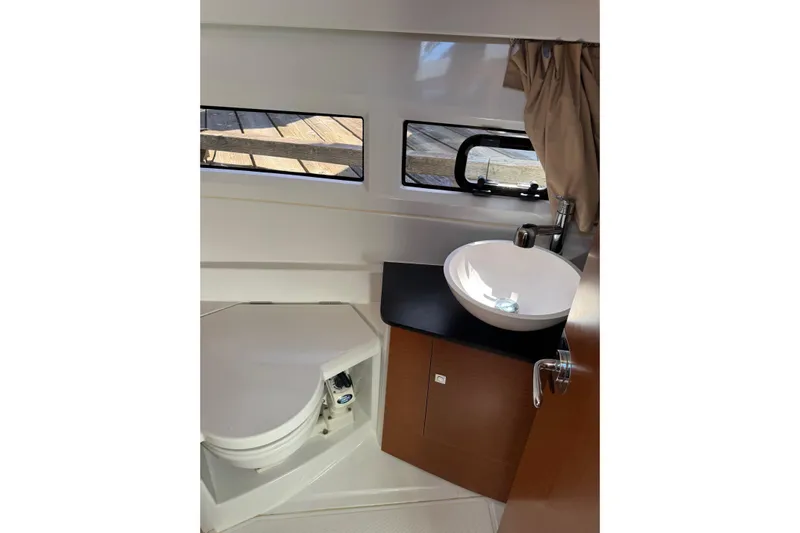  Yacht Photos Pics Bathroom interior of 2017 Jeanneau 895 Offshore boat with sink and toilet.