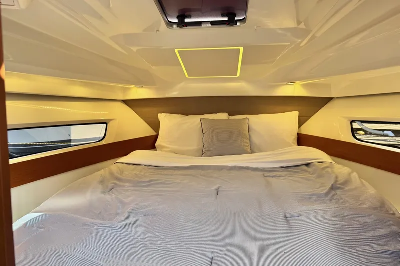  Yacht Photos Pics Cozy cabin interior of 2017 Jeanneau 895 Offshore with comfortable bedding and modern design.