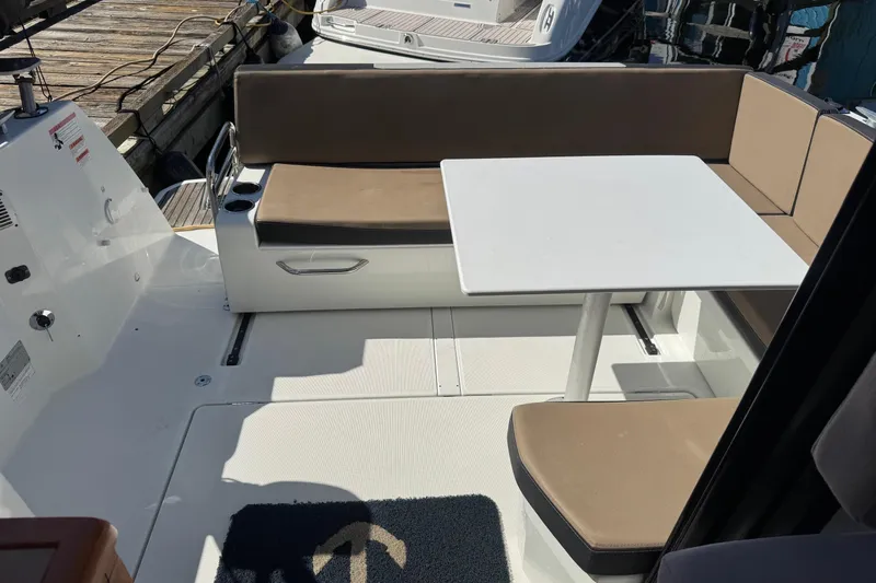  Yacht Photos Pics 2017 Jeanneau 895 Offshore boat interior with seating and table setup.