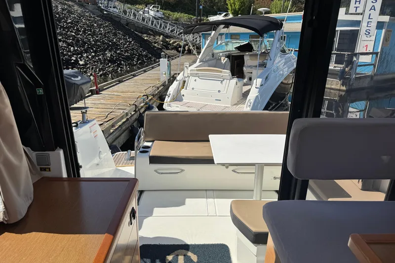  Yacht Photos Pics Interior view of 2017 Jeanneau 895 Offshore boat docked at marina.