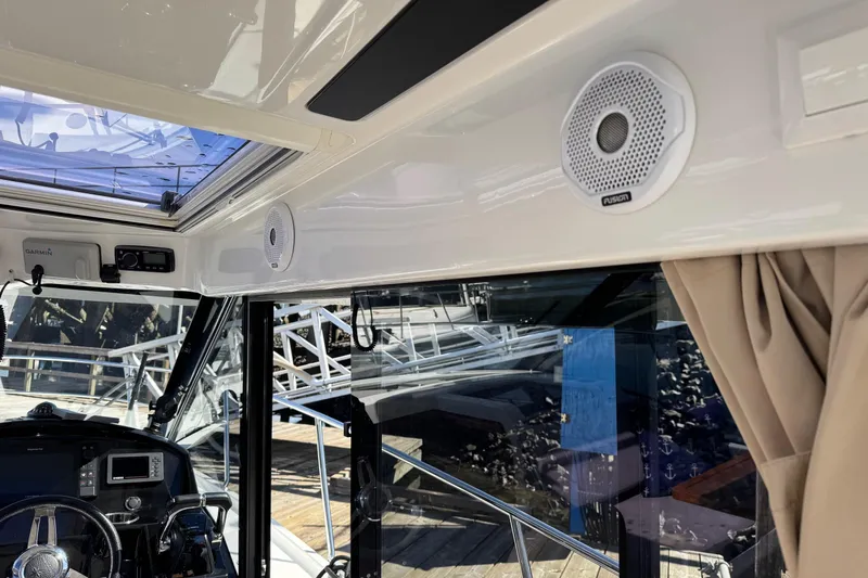  Yacht Photos Pics Interior view of 2017 Jeanneau 895 Offshore boat with speakers and navigation equipment.