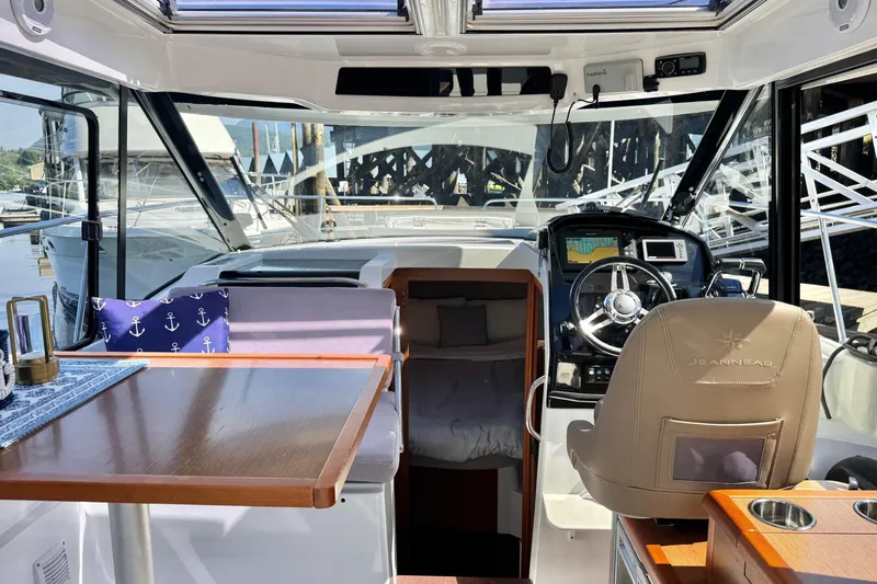  Yacht Photos Pics Interior of 2017 Jeanneau 895 Offshore boat with helm, seating, and nautical decor.