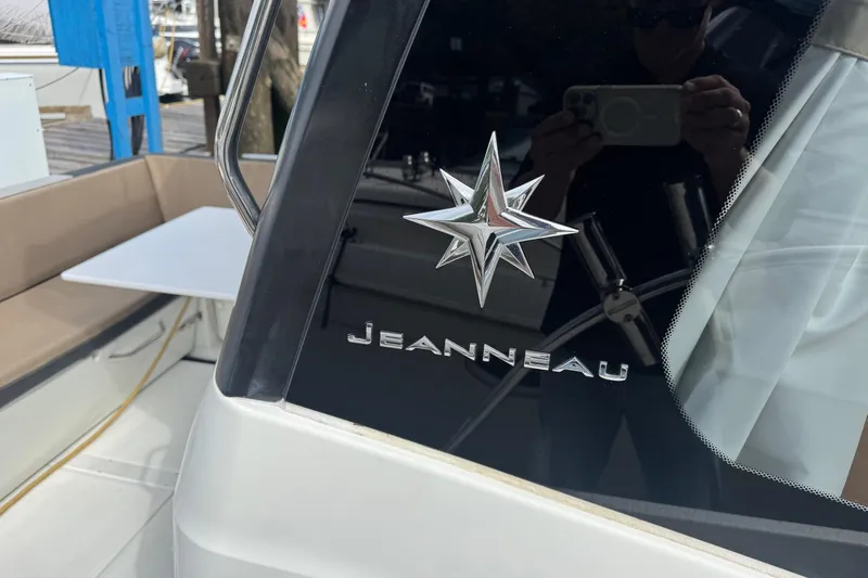  Yacht Photos Pics 2017 Jeanneau 895 Offshore boat with logo and seating area.