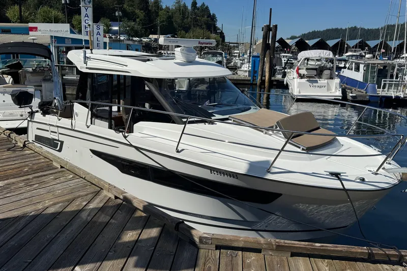  Yacht Photos Pics 2017 Jeanneau 895 Offshore yacht docked at marina, sunny day, for sale sign visible.