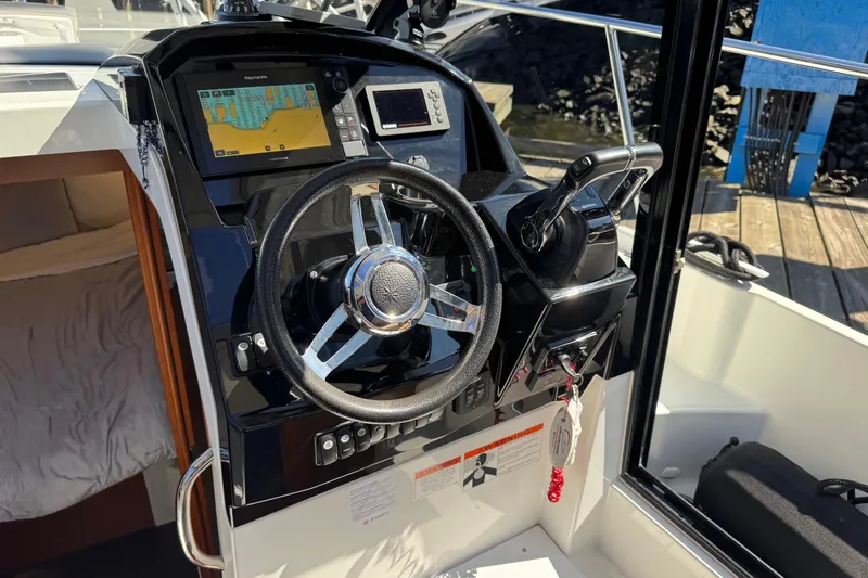  Yacht Photos Pics Helm of 2017 Jeanneau 895 Offshore boat with navigation controls and steering wheel.
