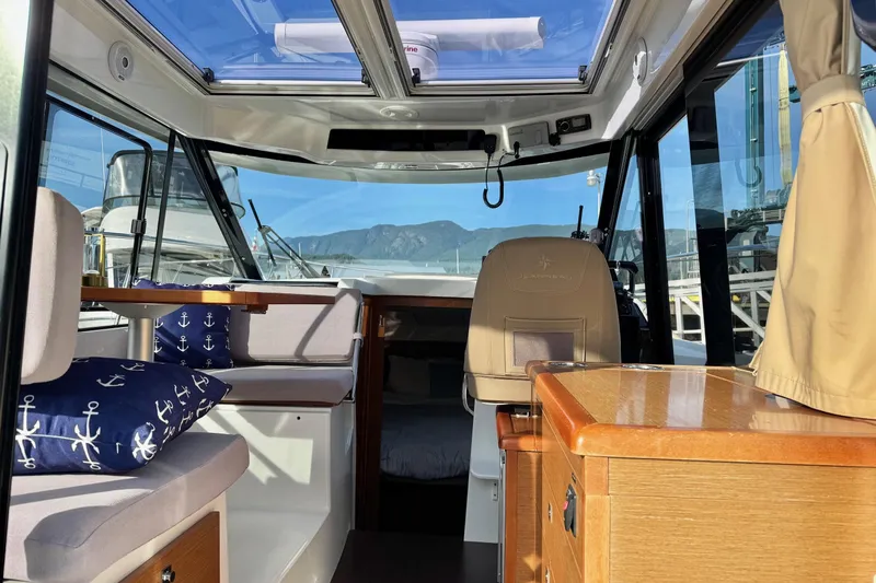  Yacht Photos Pics Interior of 2017 Jeanneau 895 Offshore boat with seating and nautical decor.