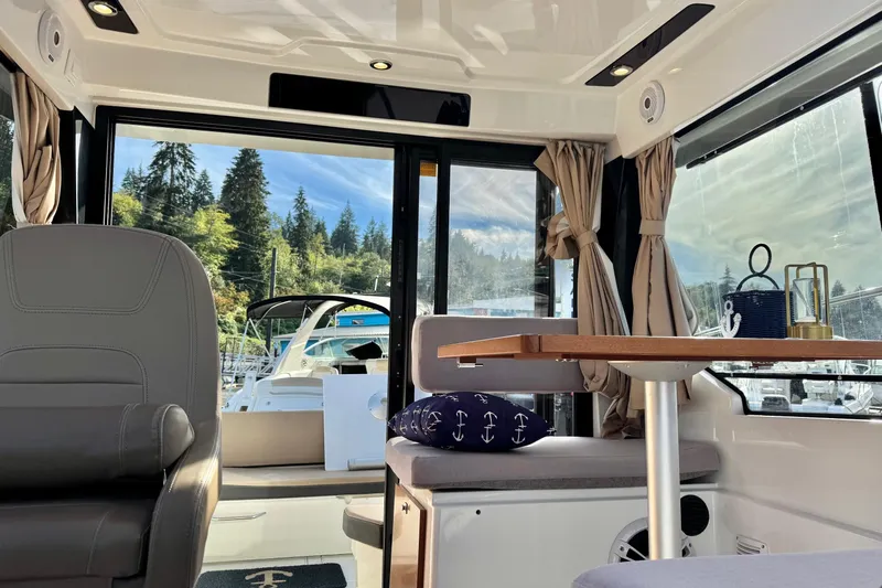  Yacht Photos Pics Interior of 2017 Jeanneau 895 Offshore boat with scenic marina view.