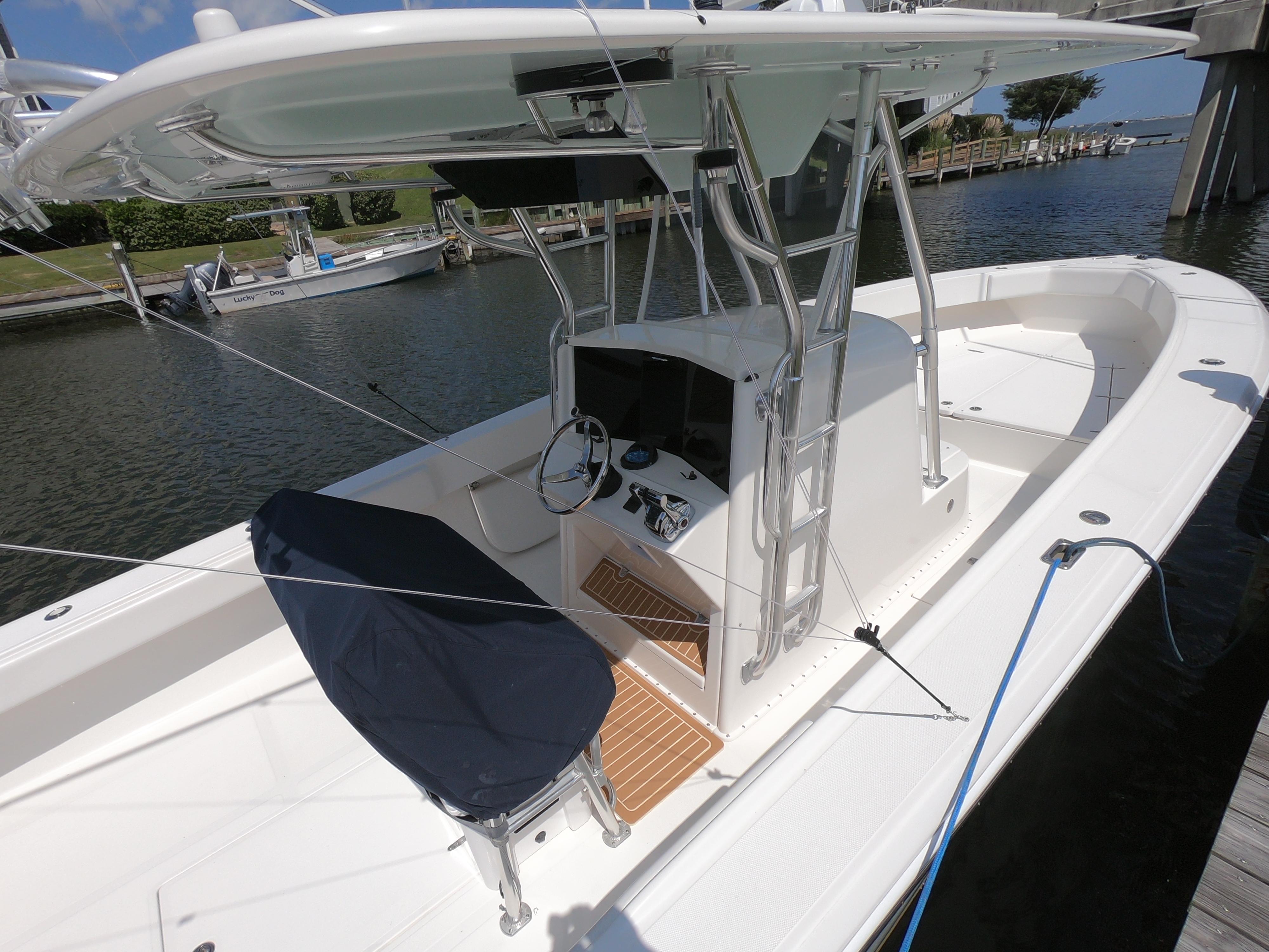 2003 Venture 34 Open boat docked, featuring a central console and covered seating.