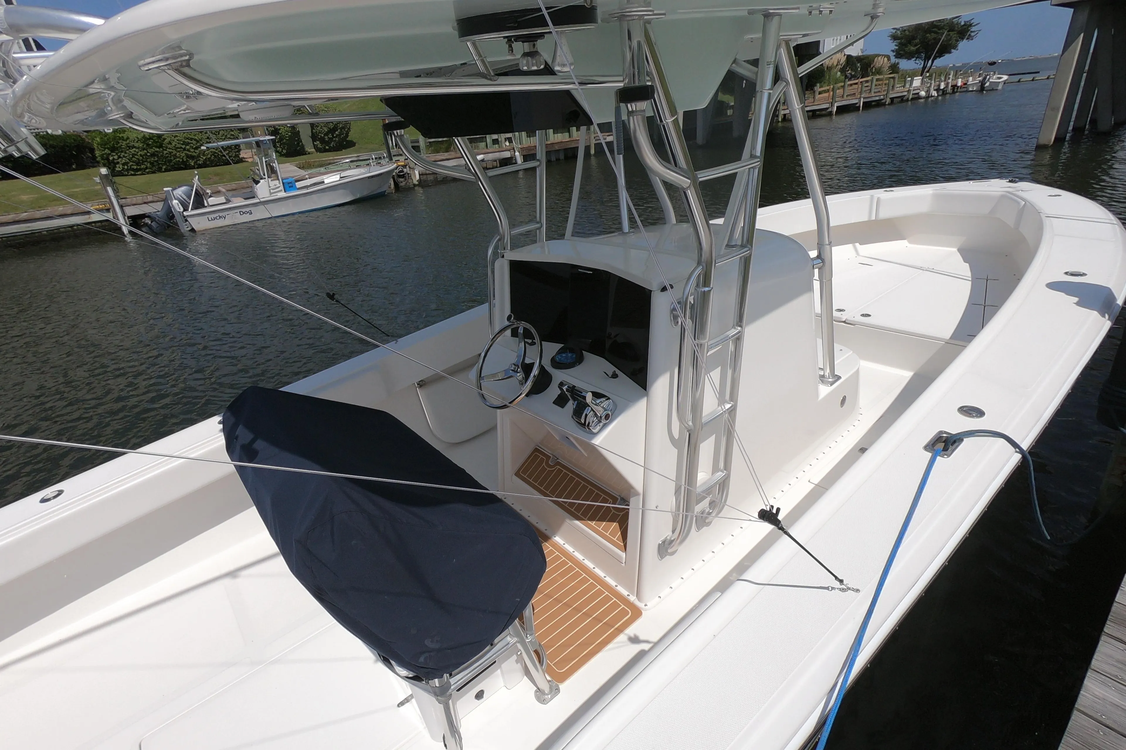 2003 Venture 34 Open boat docked, featuring a central console and covered seating.