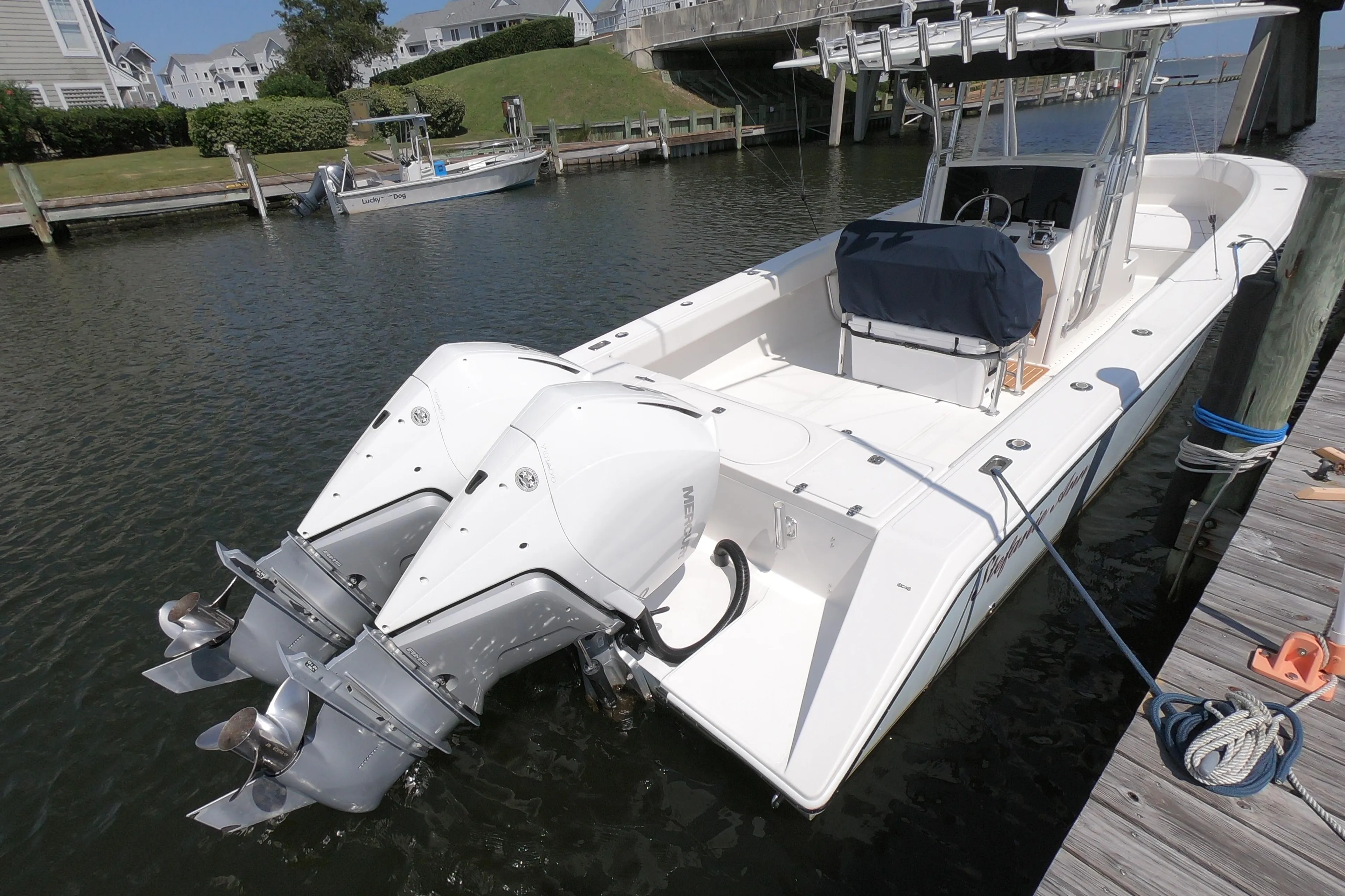 2003 Venture 34 Open boat docked, featuring dual outboard motors.