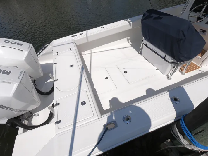  Yacht Photos Pics 2003 Venture 34 Open boat deck with dual Mercury engines, docked on calm water.