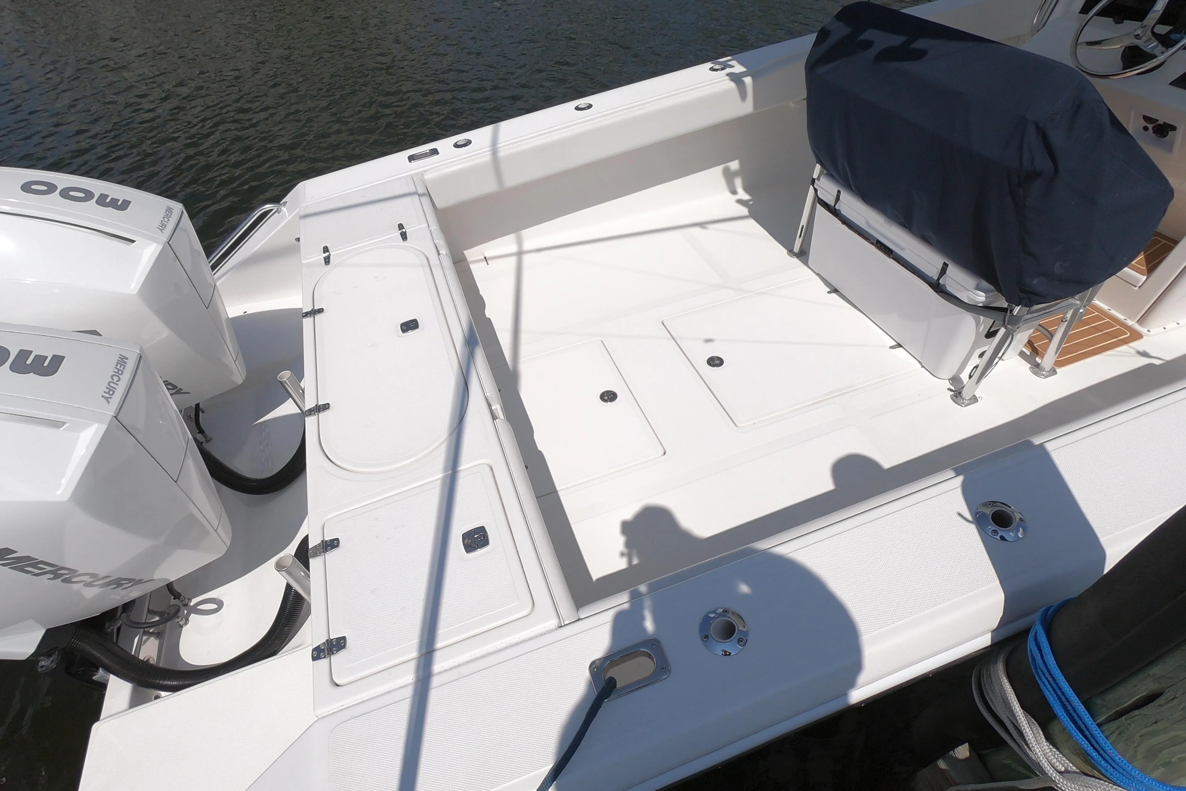 2003 Venture 34 Open boat deck with dual Mercury engines, docked on calm water.