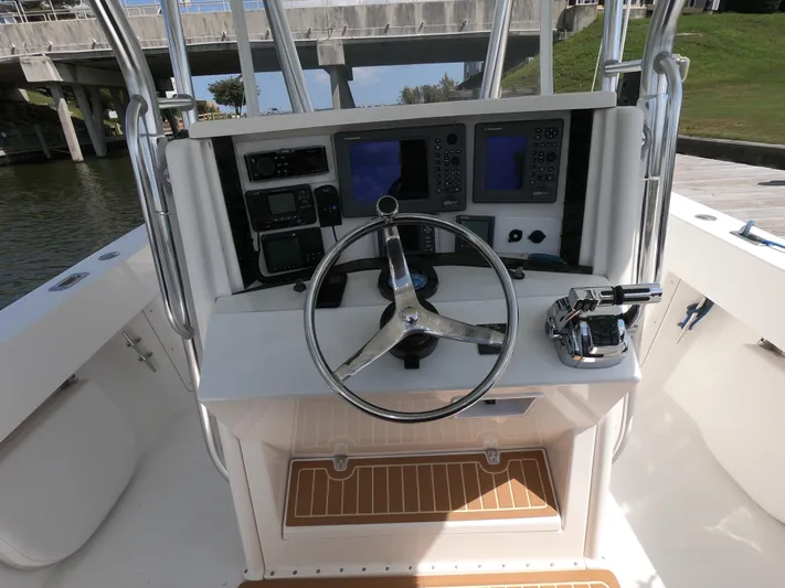  Yacht Photos Pics 2003 Venture 34 Open boat helm with steering wheel and navigation controls.