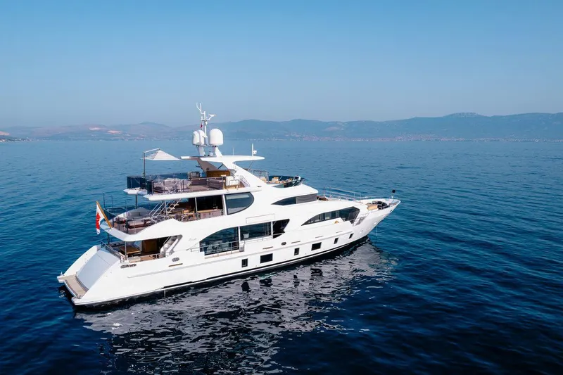 Afina Yacht Photos Pics Luxurious 2017 Benetti 108 yacht cruising on serene blue waters.