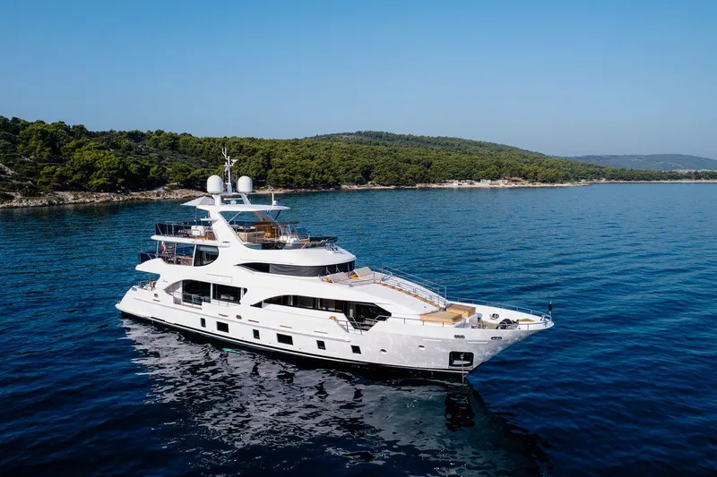 Afina Yacht Photos Pics Luxurious 2017 Benetti 108 yacht cruising near a scenic coastline.