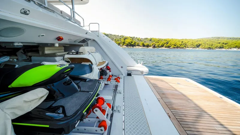 Afina Yacht Photos Pics Luxury Benetti 108 yacht with jet ski storage, 2017 model, docked by scenic coastline.