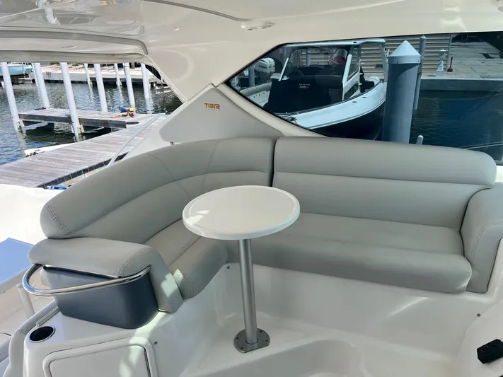 Nola Yacht Photos Pics 2007 Tiara Yachts 3900 Sovran interior with gray seating and small round table.
