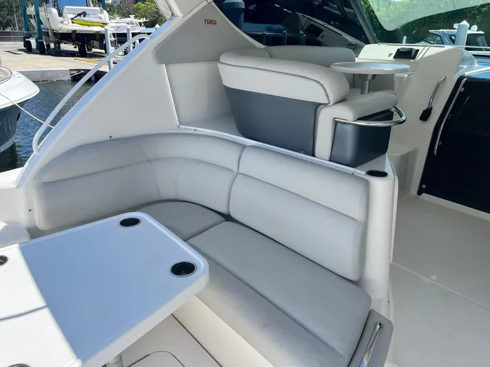 Nola Yacht Photos Pics 2007 Tiara Yachts 3900 Sovran interior with white leather seating and table.