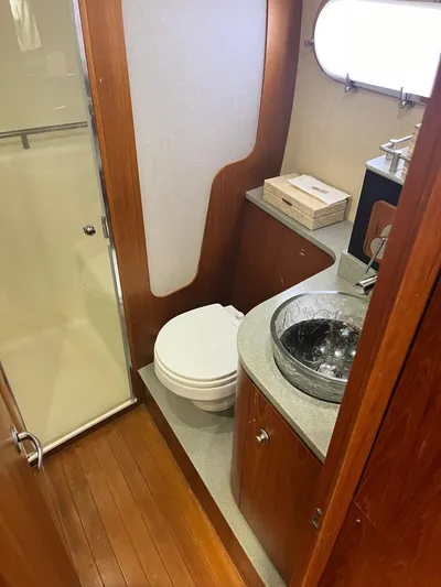 Nola Yacht Photos Pics 2007 Tiara Yachts 3900 Sovran bathroom with wood accents and modern fixtures.
