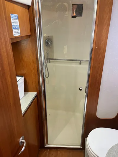 Nola Yacht Photos Pics 2007 Tiara Yachts 3900 Sovran bathroom with shower and wooden cabinetry.