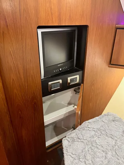 Nola Yacht Photos Pics 2007 Tiara Yachts 3900 Sovran interior with built-in TV and wooden cabinetry.