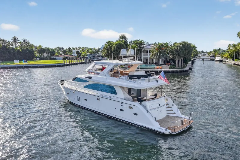 Arlene Yacht Photos Pics Luxurious 2009 Horizon Flybridge yacht cruising on a scenic waterway.