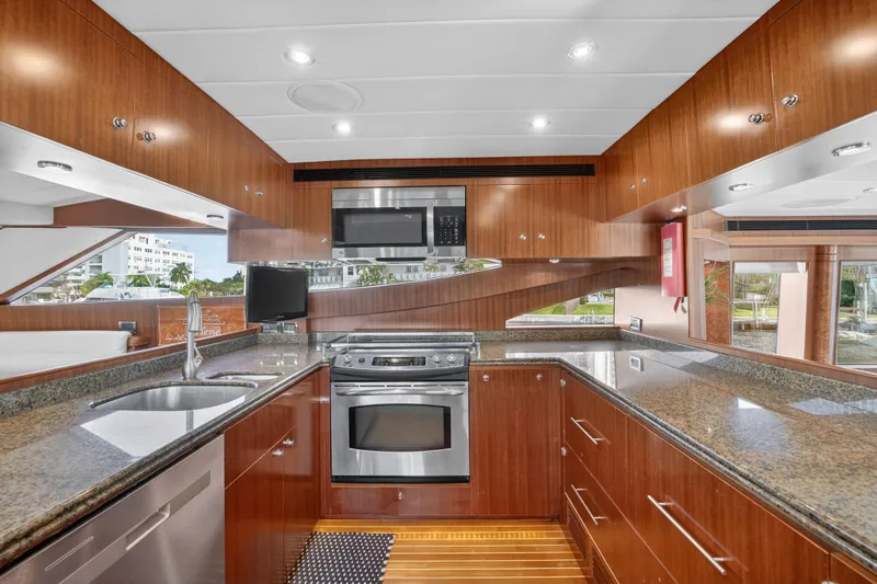 Arlene Yacht Photos Pics Luxurious 2009 Horizon Flybridge yacht kitchen with modern appliances and sleek wood cabinetry.
