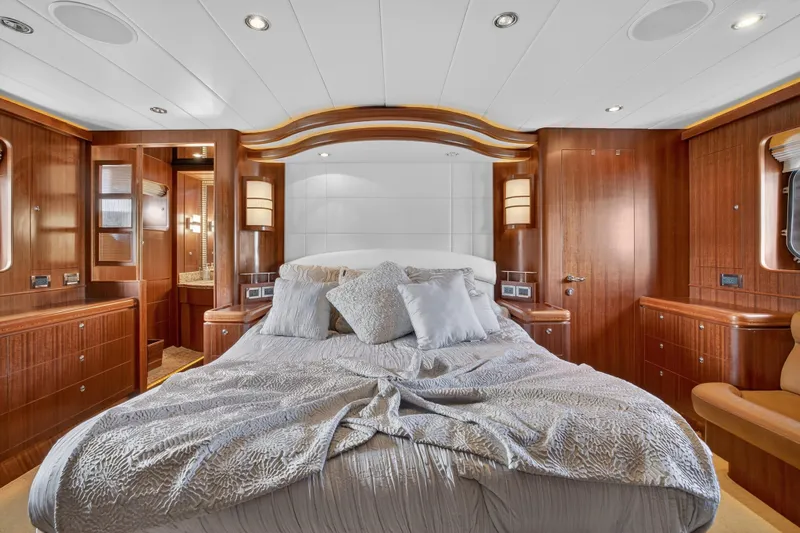 Arlene Yacht Photos Pics Luxurious 2009 Horizon Flybridge yacht bedroom with elegant wood paneling and plush bedding.