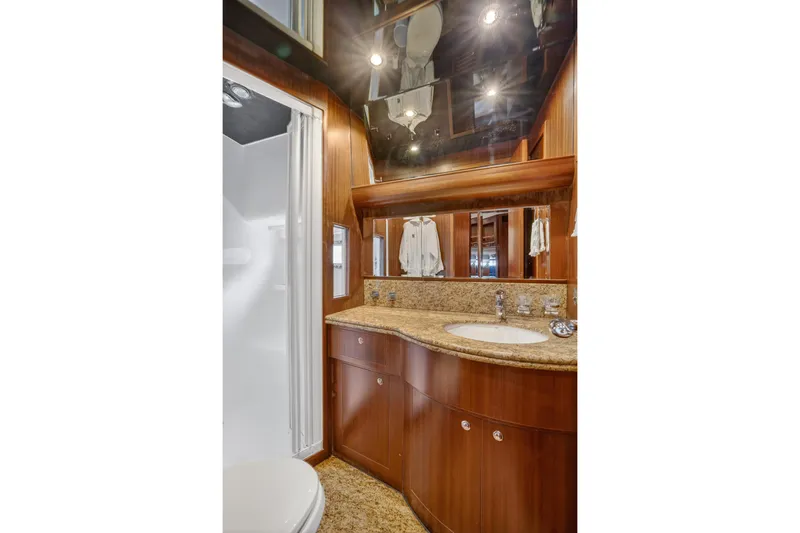 Arlene Yacht Photos Pics Luxurious bathroom in 2009 Horizon Flybridge yacht with wood cabinetry and granite countertop.