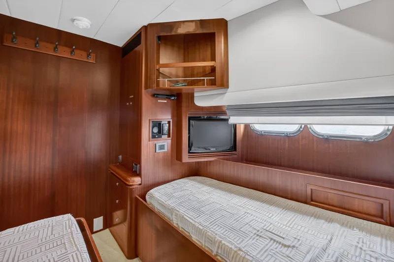 Arlene Yacht Photos Pics Luxurious 2009 Horizon Flybridge yacht cabin with wooden interior and twin beds.