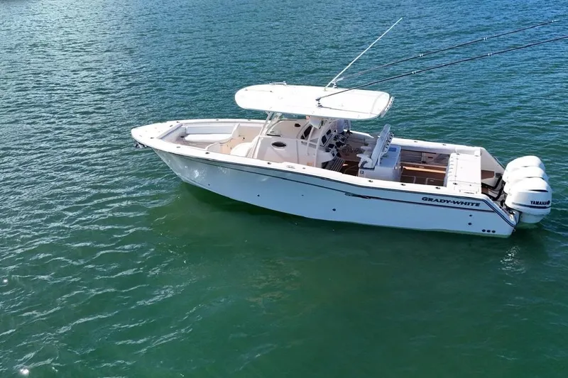  Yacht Photos Pics 2018 Grady-White Canyon 336 boat on clear blue water, featuring dual Yamaha engines.