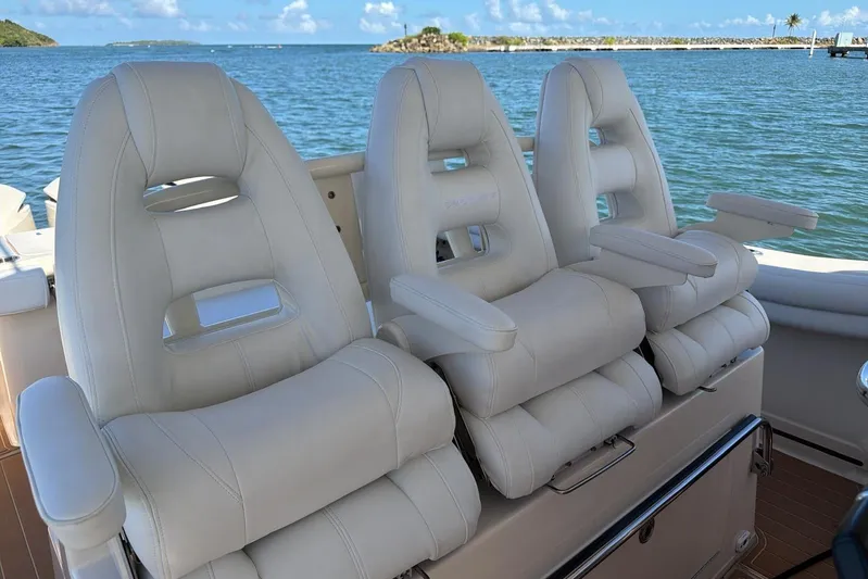  Yacht Photos Pics Luxurious seating on 2018 Grady-White Canyon 336 boat with scenic ocean backdrop.