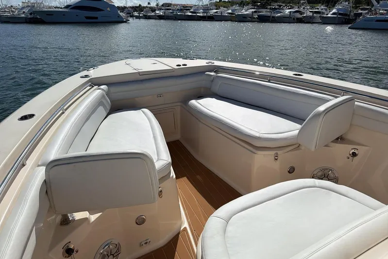  Yacht Photos Pics 2018 Grady-White Canyon 336 boat interior with white seating, docked at marina.